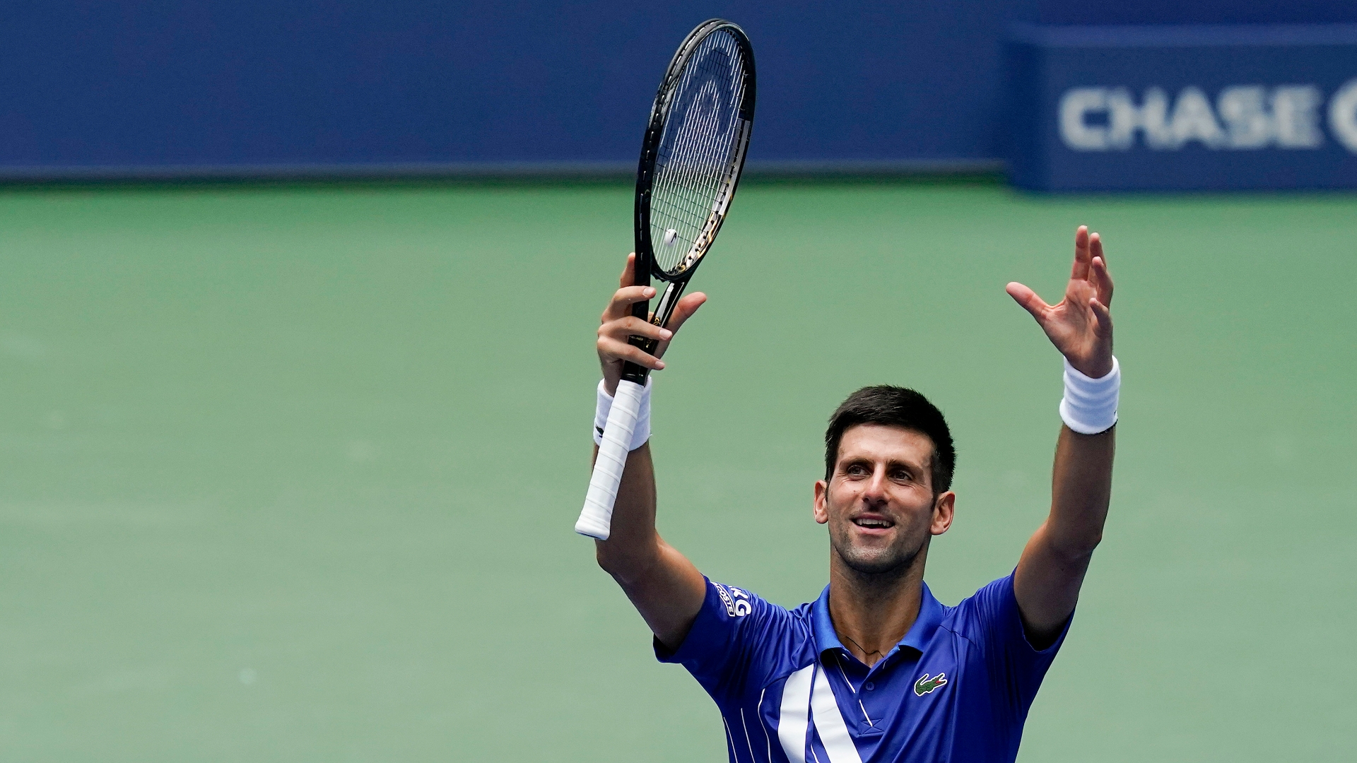 Djokovic wins match, salutes invisible crowd