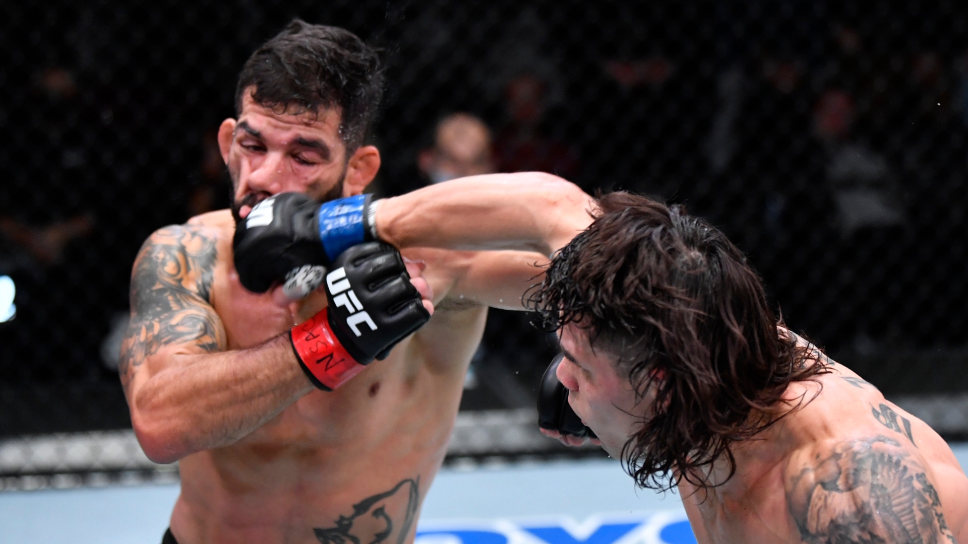 Ricky Simón landing a right hand in the Octagon