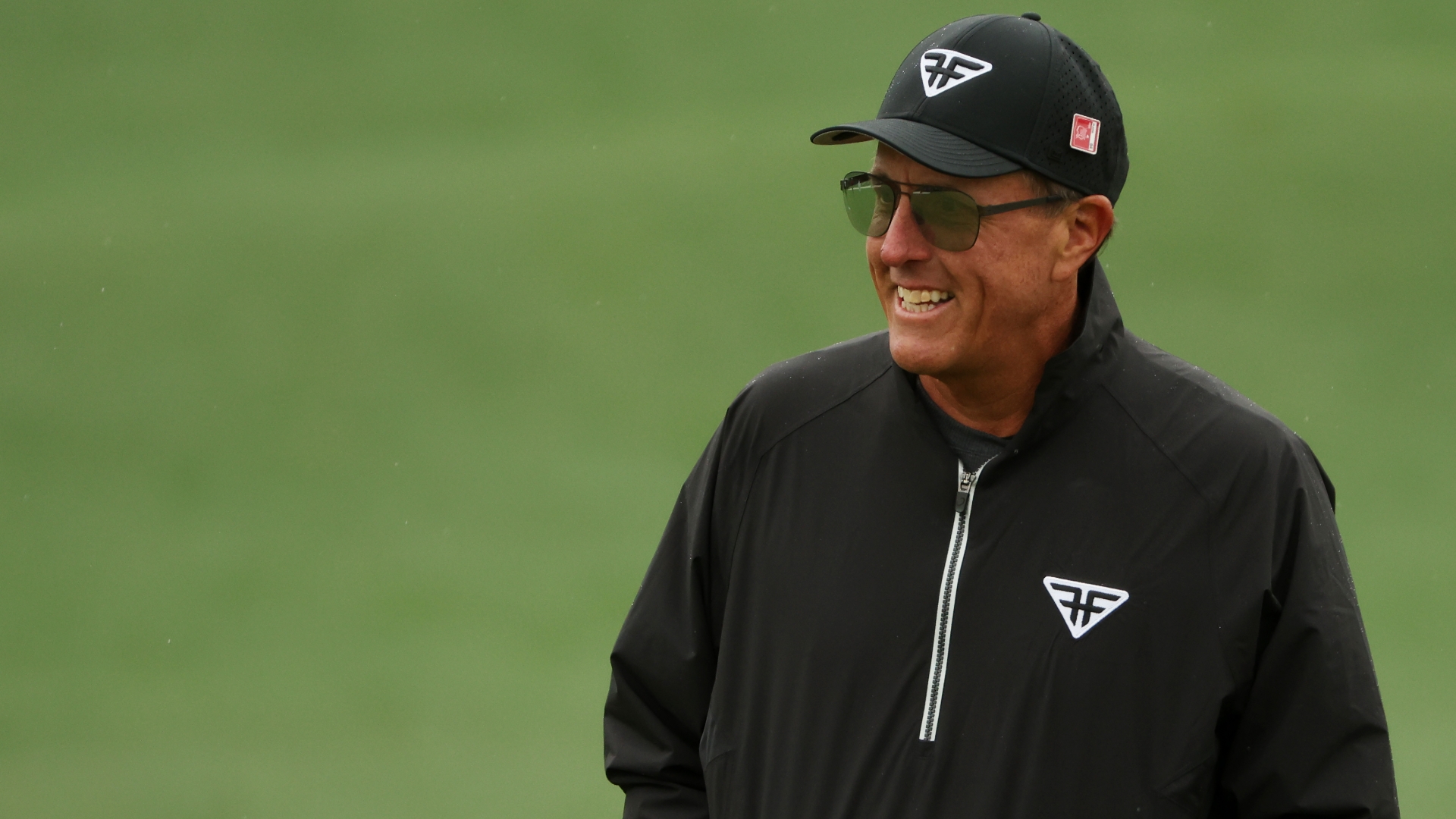 Phil Mickelson raises a fist as he knocks down long birdie putt on 6