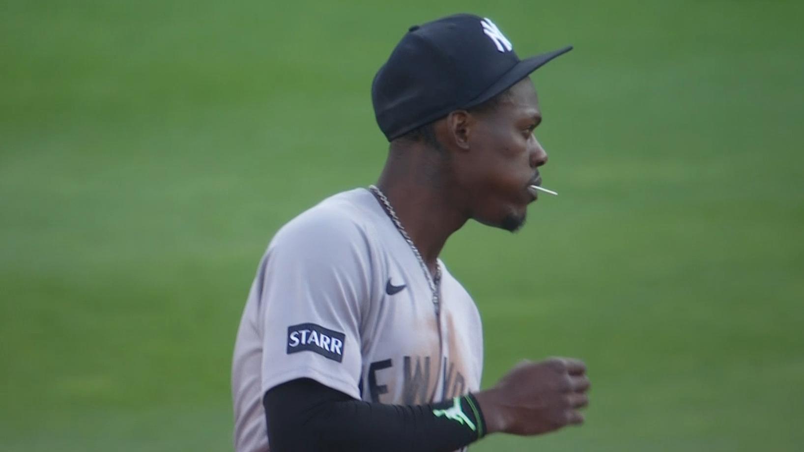 Jazz Chisholm Jr. eats a lollipop while in the field