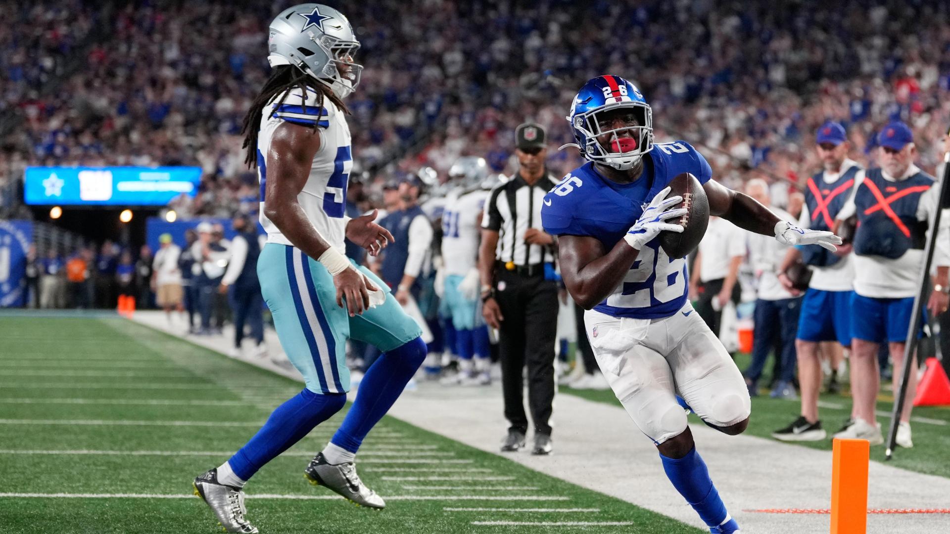 Giants' offense rolls over the Cowboys to give coach John Harbaugh a 28-20 win in his debut