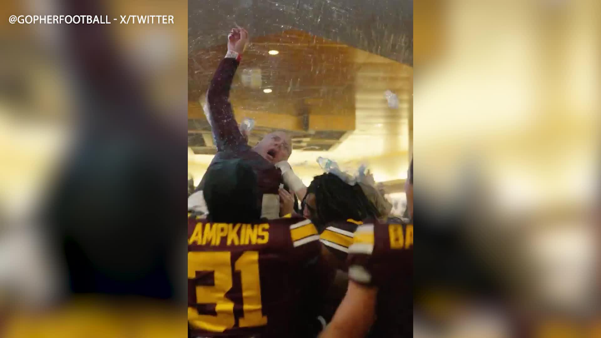 Coach P.J. Fleck crowd surfs in locker room after Minnesota upsets Michigan